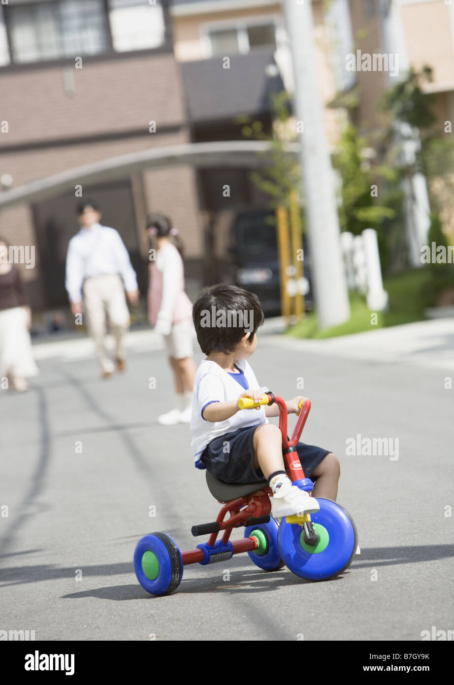 A boy riding tricycle Stock Photo Alamy
