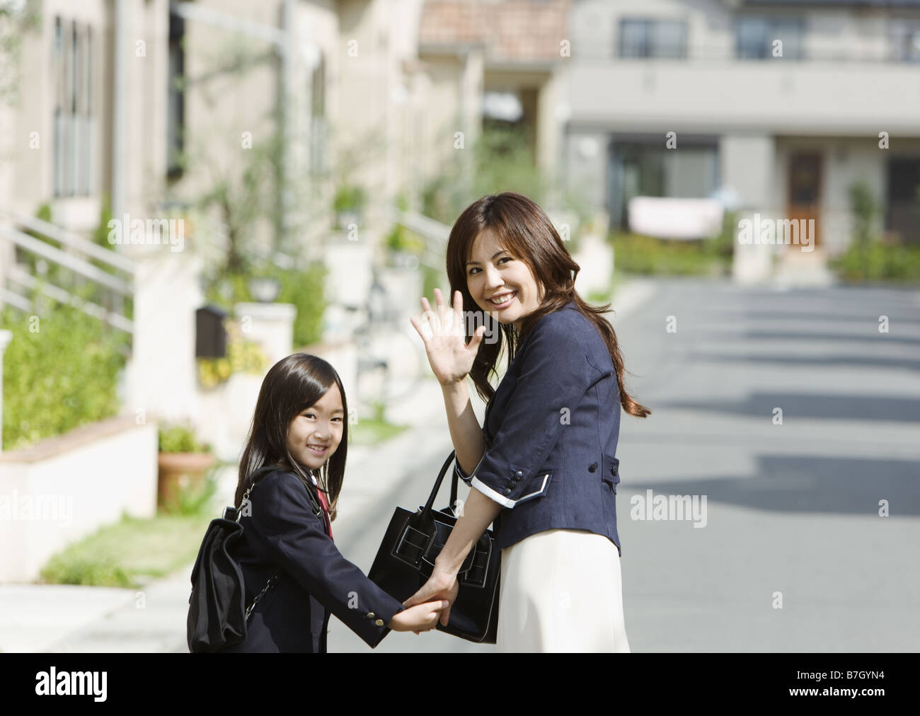 Mother and daughter walking at the residential district Stock Photo