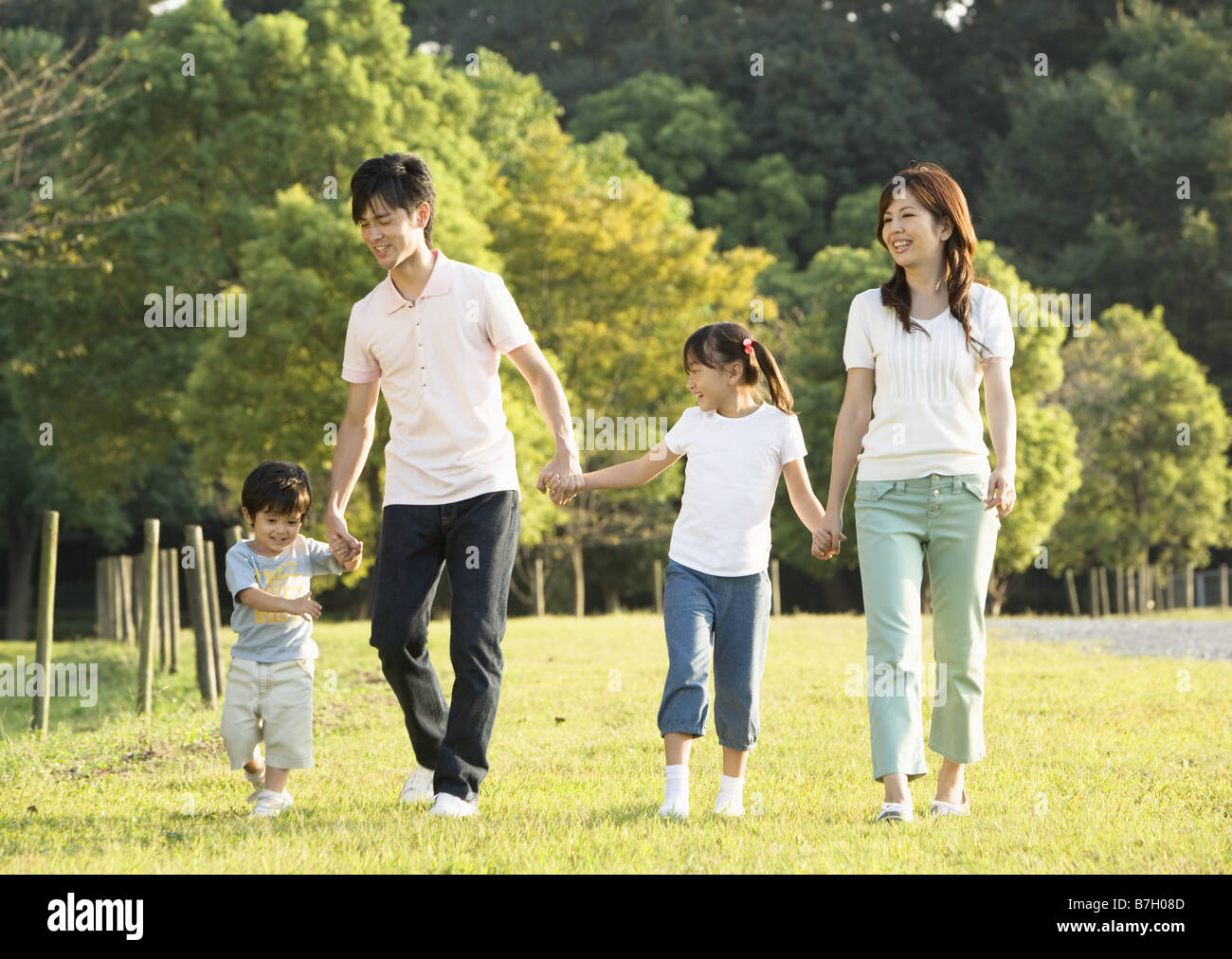 Family walking in the park Stock Photo - Alamy