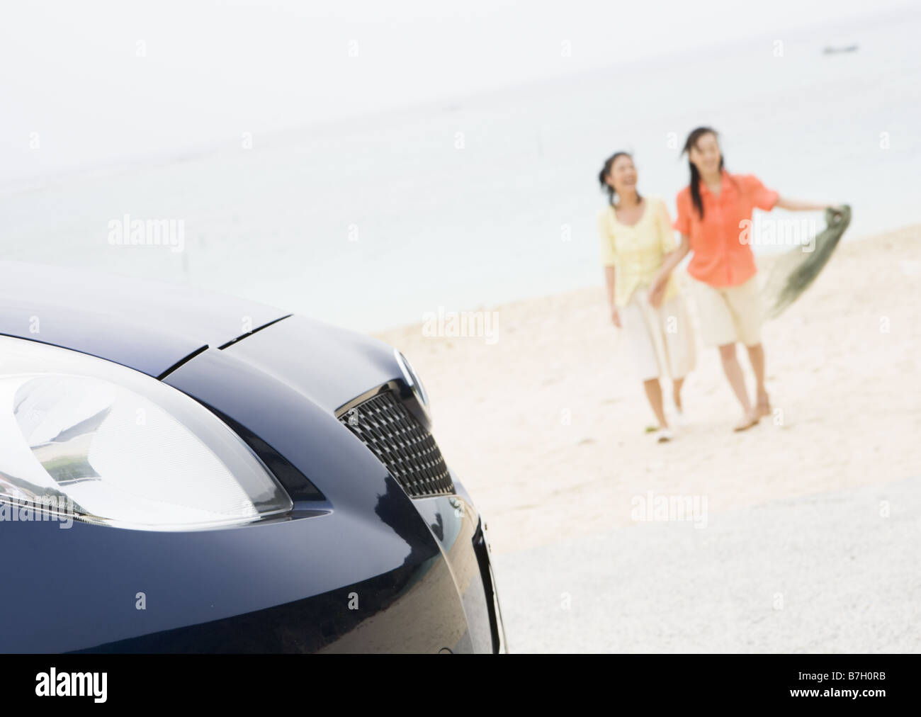 Two women taking a walk on a beach Stock Photo - Alamy