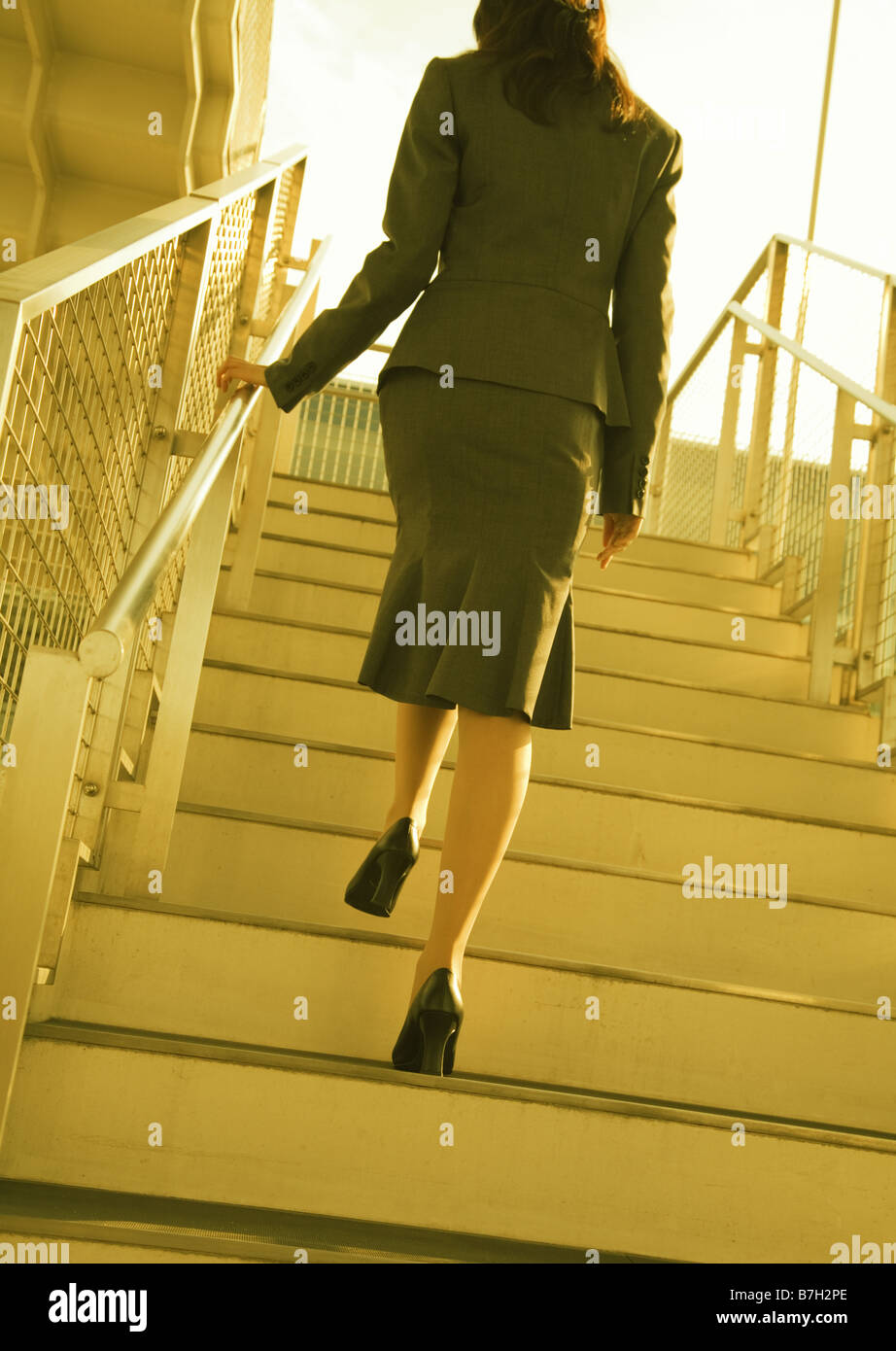Woman walking up stairs Stock Photo Alamy
