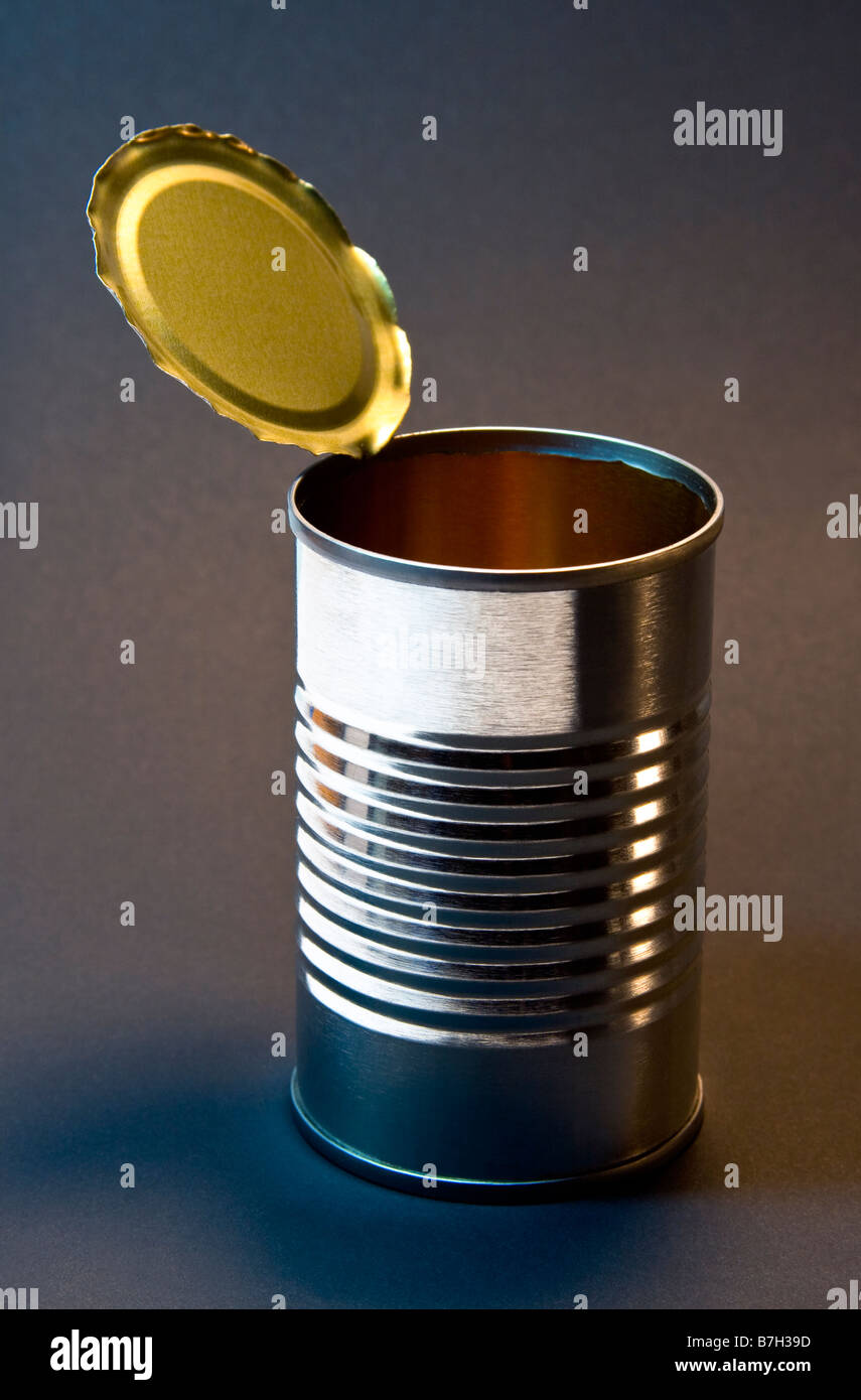 Opened, empty tin can without label on a gray background. Stock Photo