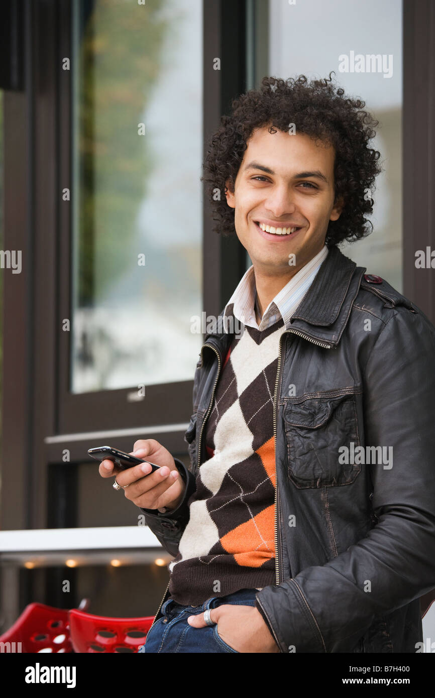 Middle Eastern man text messaging on cell phone Stock Photo