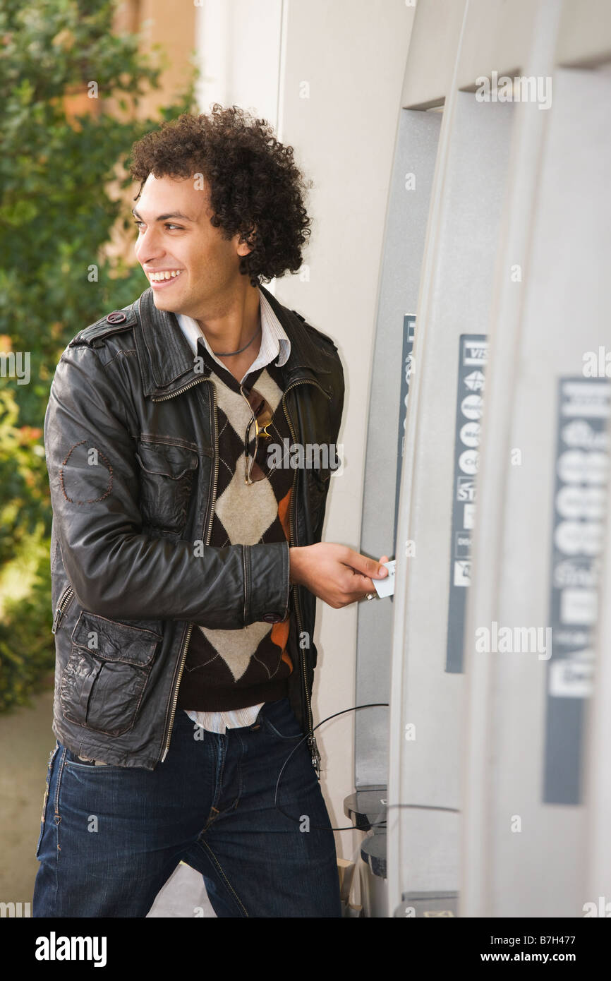 Middle Eastern man at ATM Stock Photo