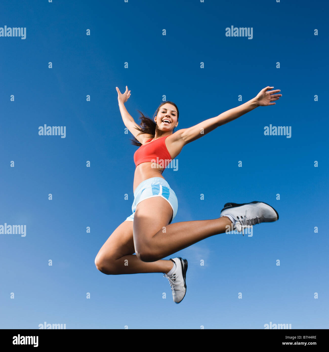 Native American woman jumping in mid-air Stock Photo