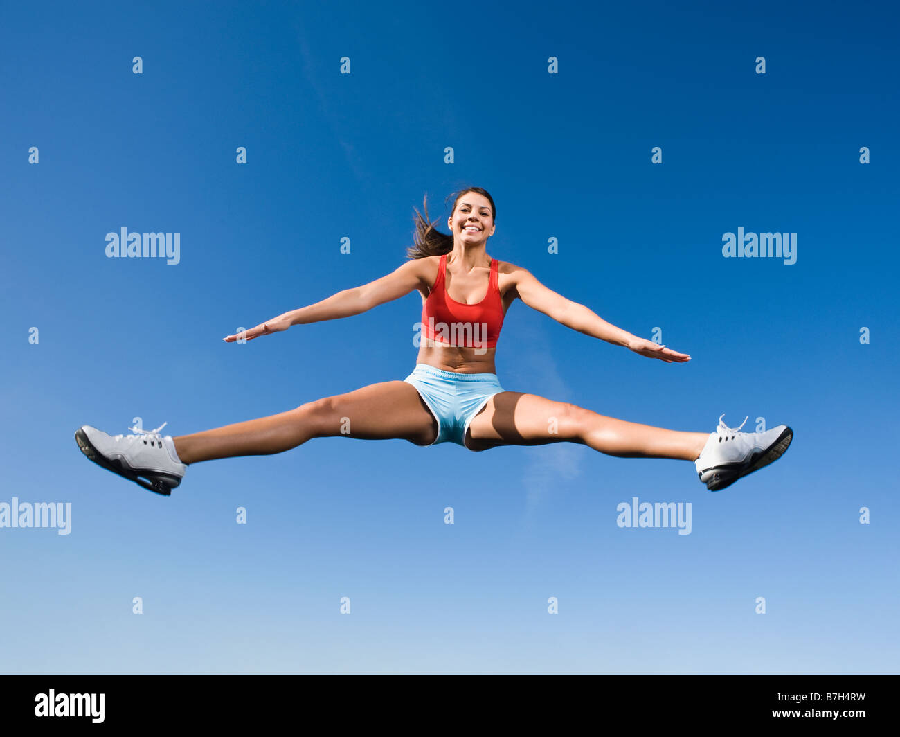 Native American woman jumping in mid-air Stock Photo