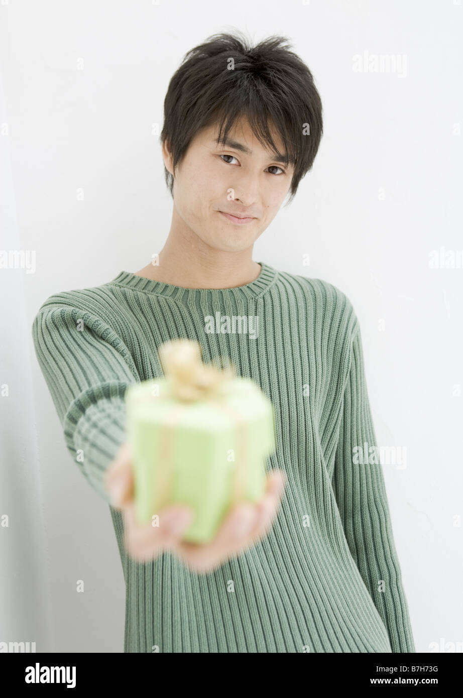 Guy Offering Man offering green gift box hi-res stock photography and images - Alamy