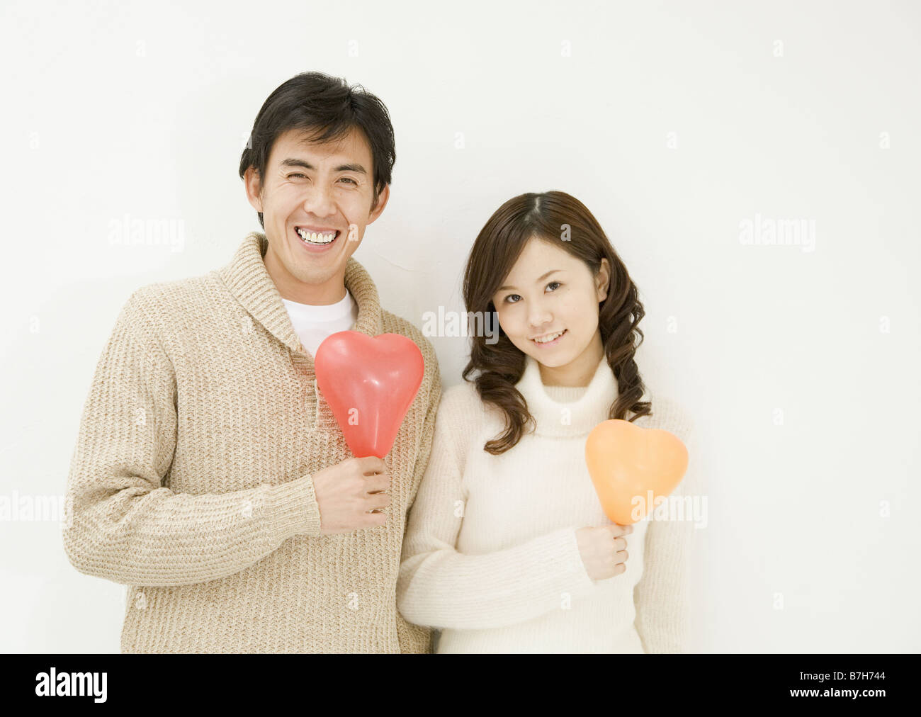 Couple Holding Heart Balloon Stock Photo - Alamy