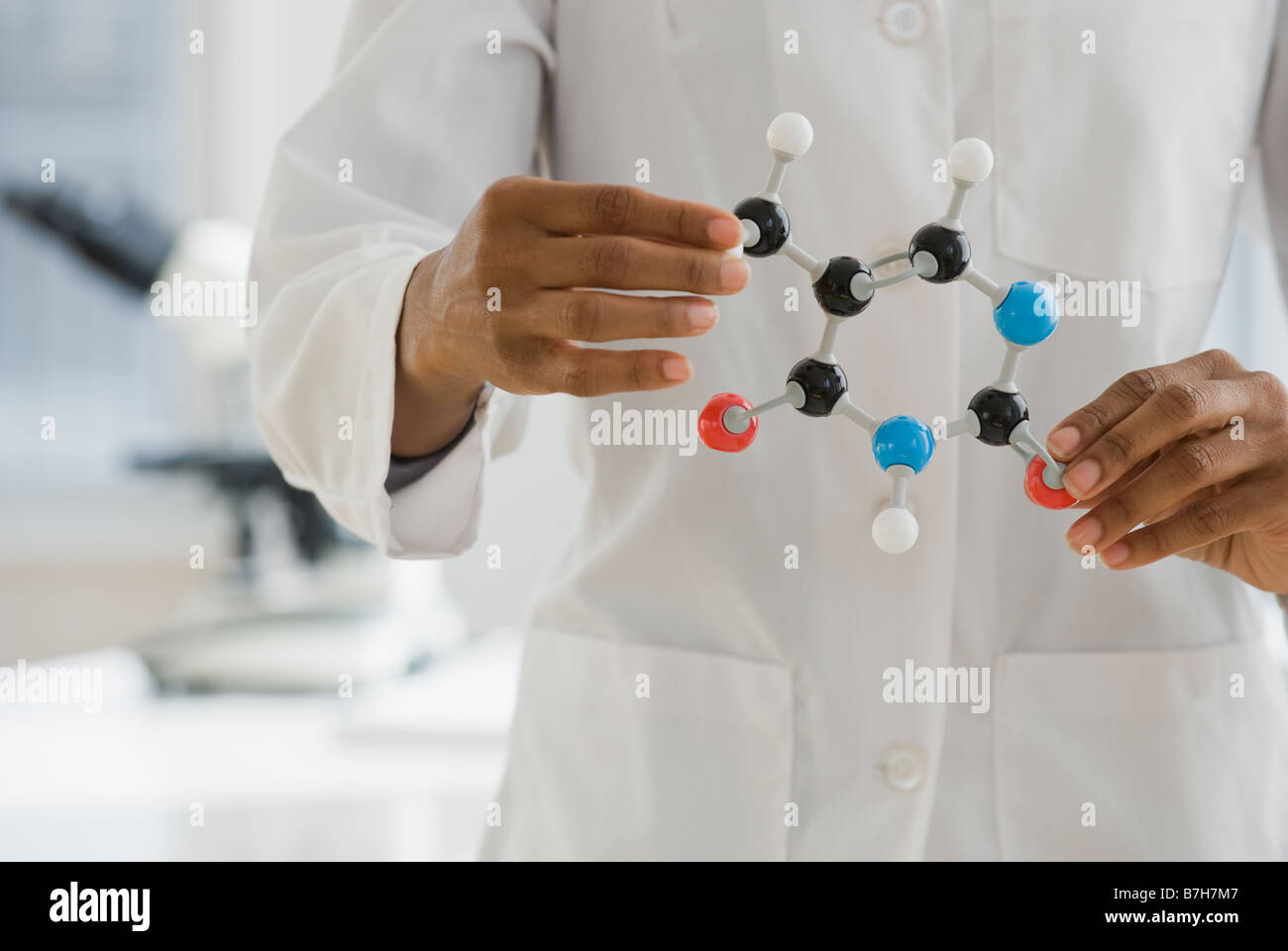 African scientist holding molecule model Stock Photo