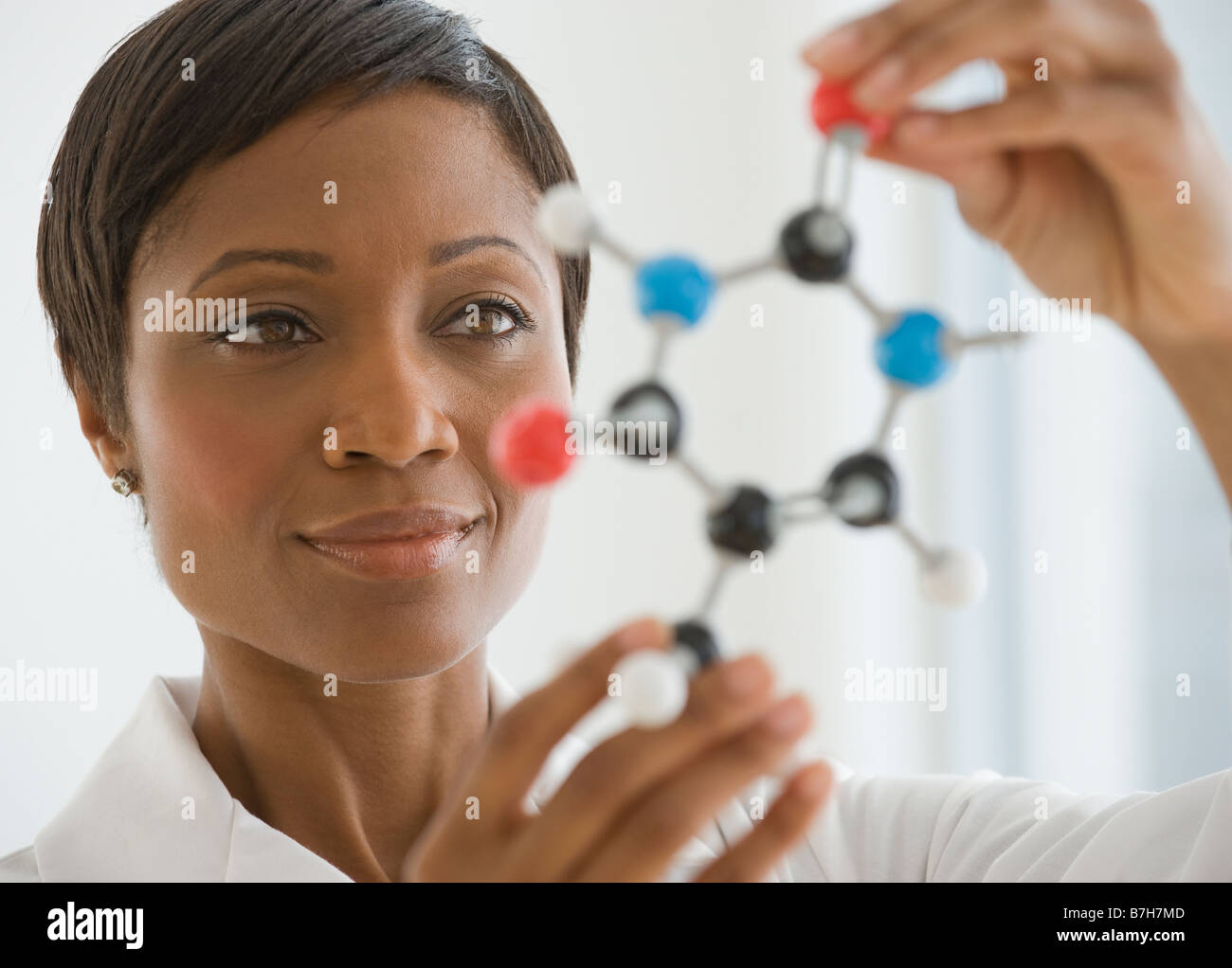 African scientist holding molecule model Stock Photo