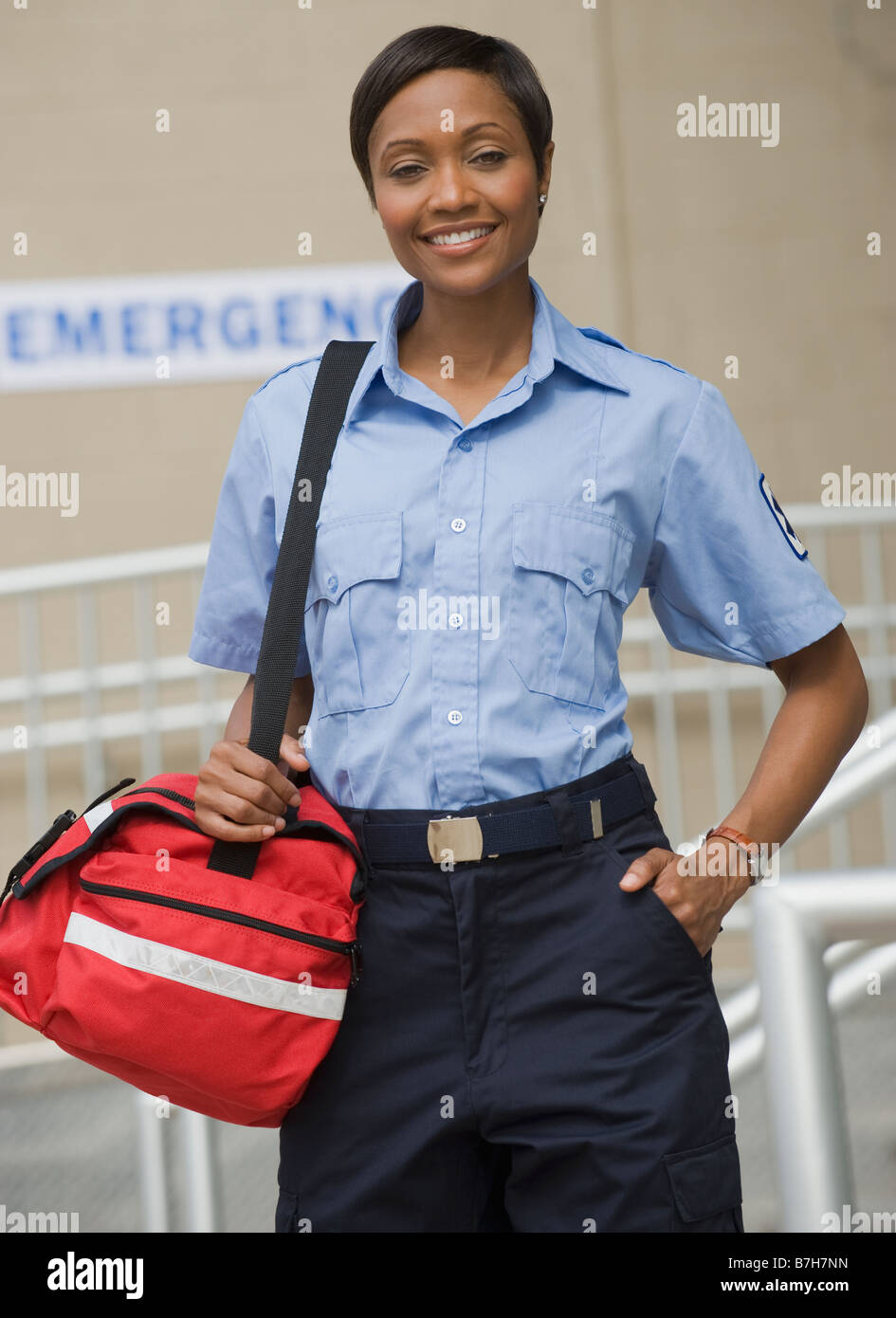 African paramedic holding first-aid kit Stock Photo