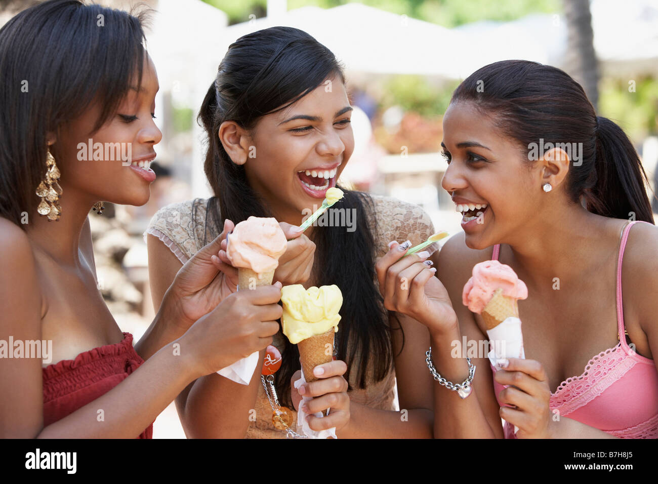 Teenage friends eating ice cream cones Stock Photo