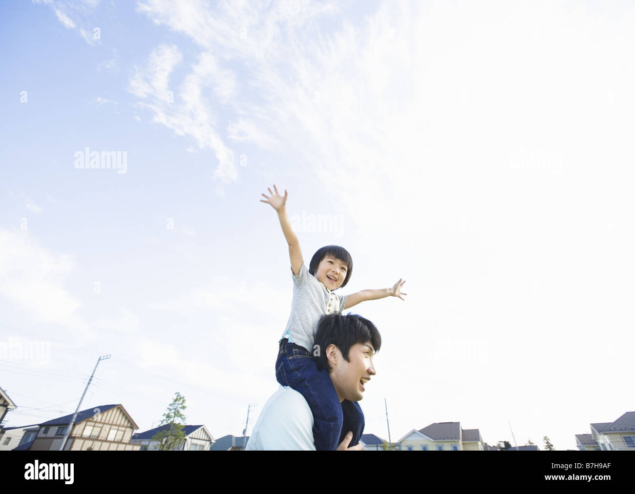 Father carrying son on his shoulders Stock Photo - Alamy