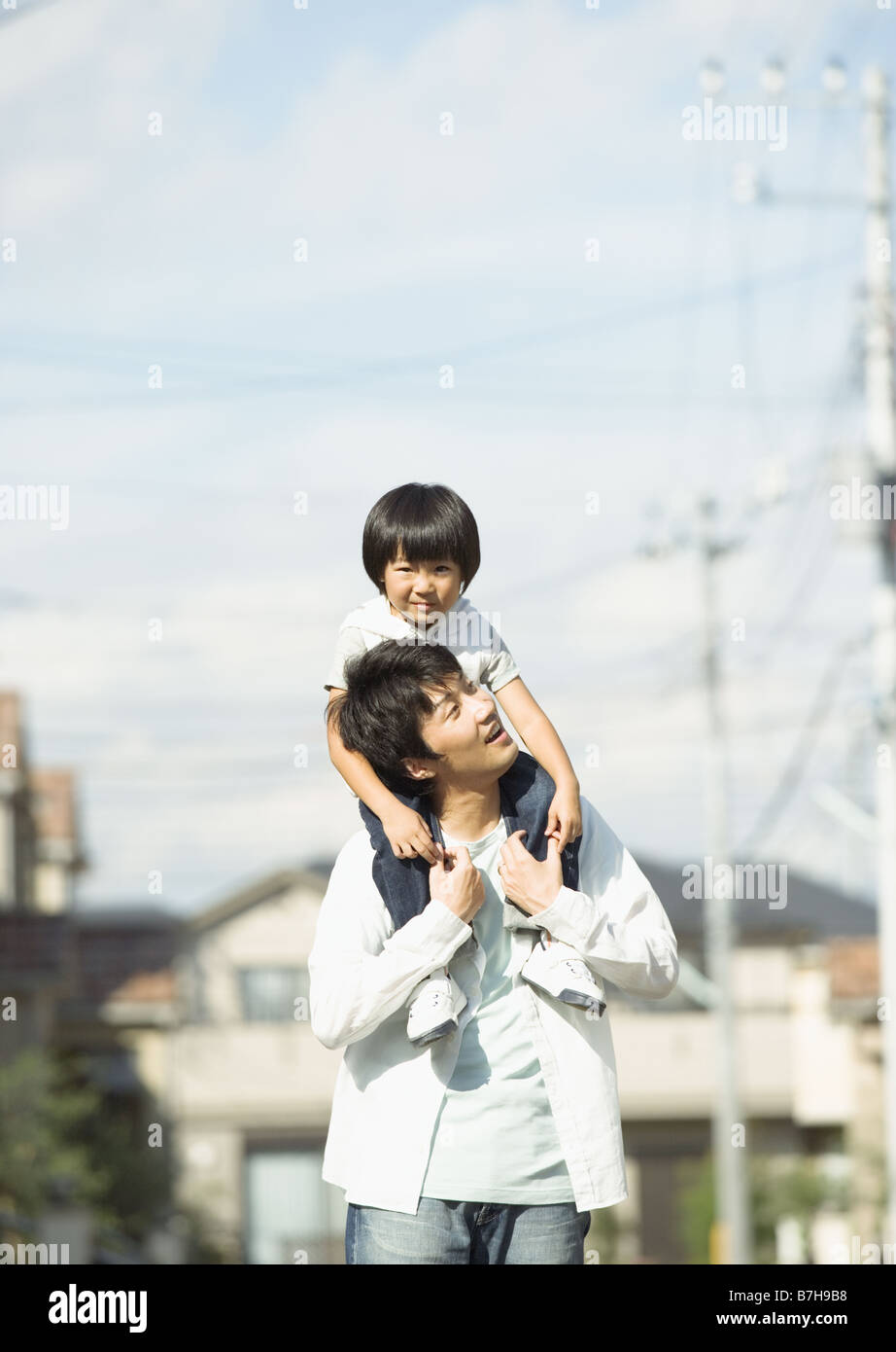 Father carrying son on his shoulders Stock Photo - Alamy