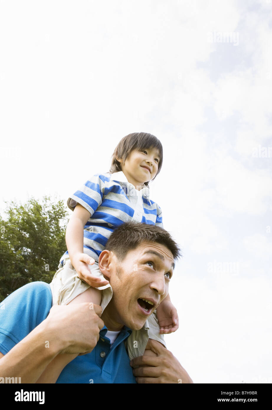 Father carrying son on his shoulders Stock Photo - Alamy