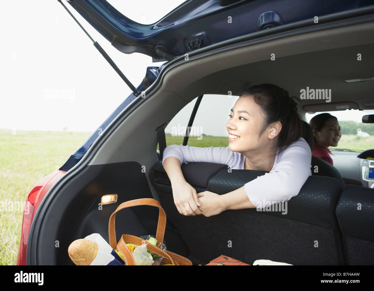 A woman with opening car trunk Stock Photo Alamy