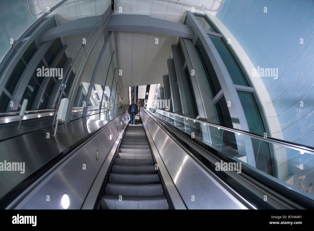 Businessman passenger on escalator at Gatwick Airport London England UK