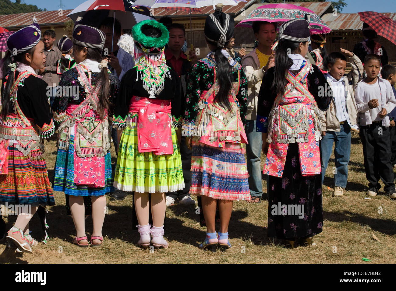 The rear view of a number of Hmong girls in traditional costume at a ...