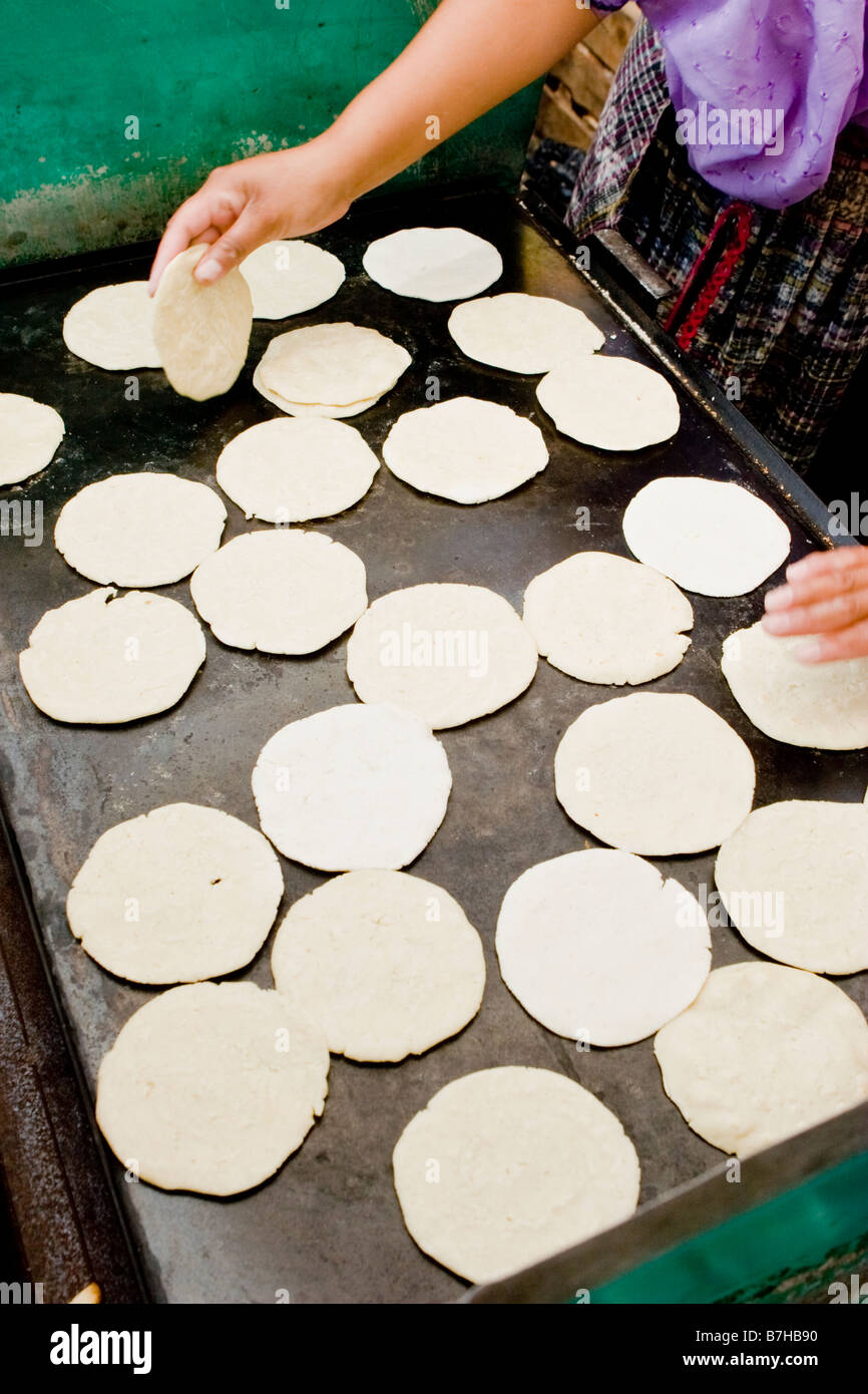 Nutritious handmade corn tortilla cooked on a metal griddle on a gas stove  in a Guatemalan home Stock Photo - Alamy