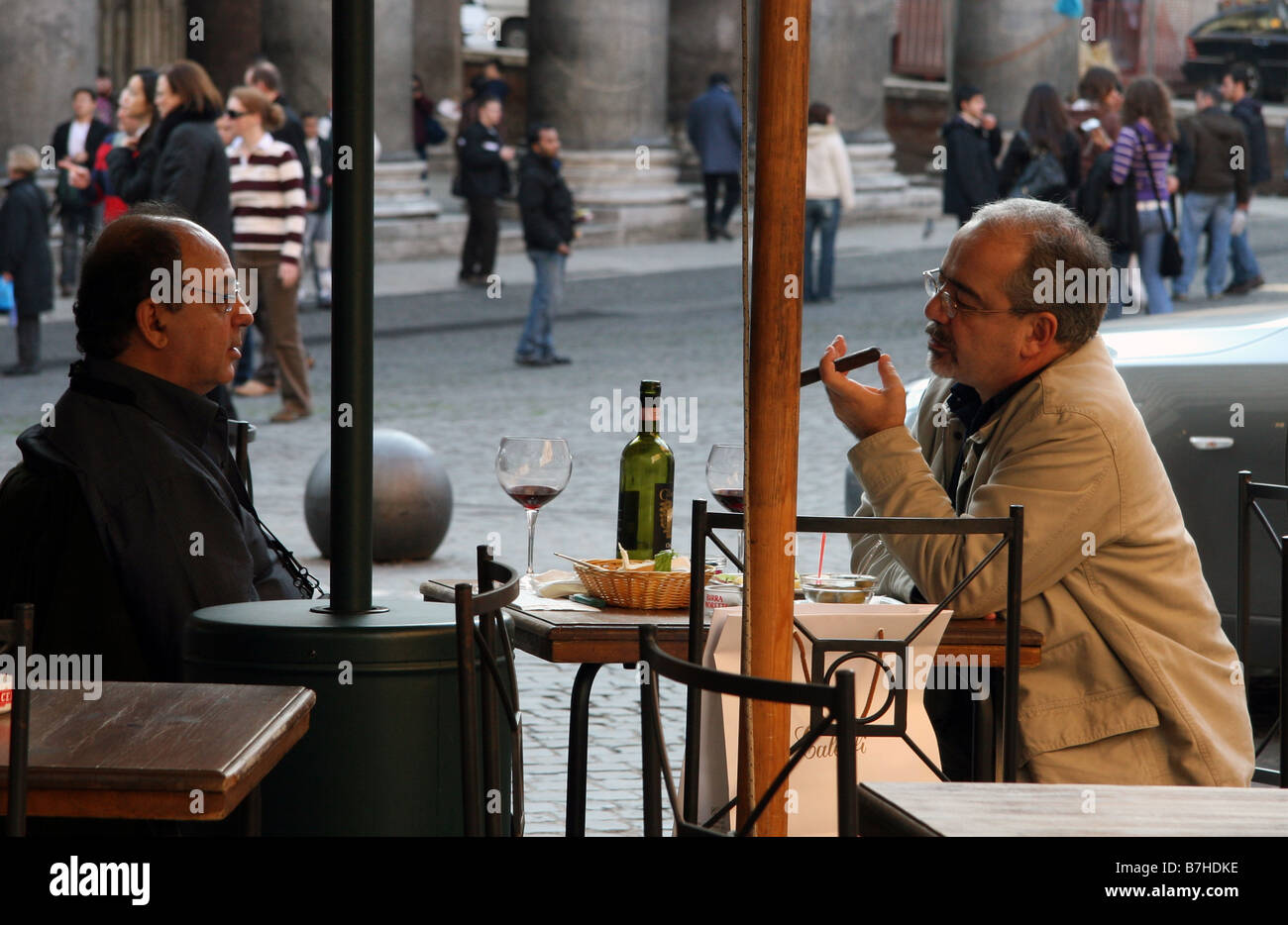 Two men drinking wine and smoking cigar in front of Pantheon in Rome