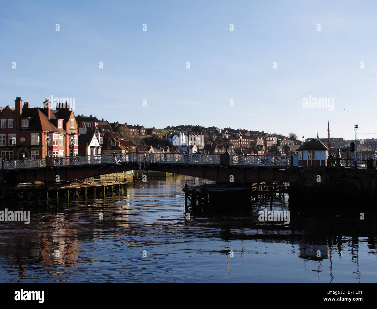 Whitby swing bridge upstream view with clear blue sky on a sunny day and highly reflective still water Stock Photo