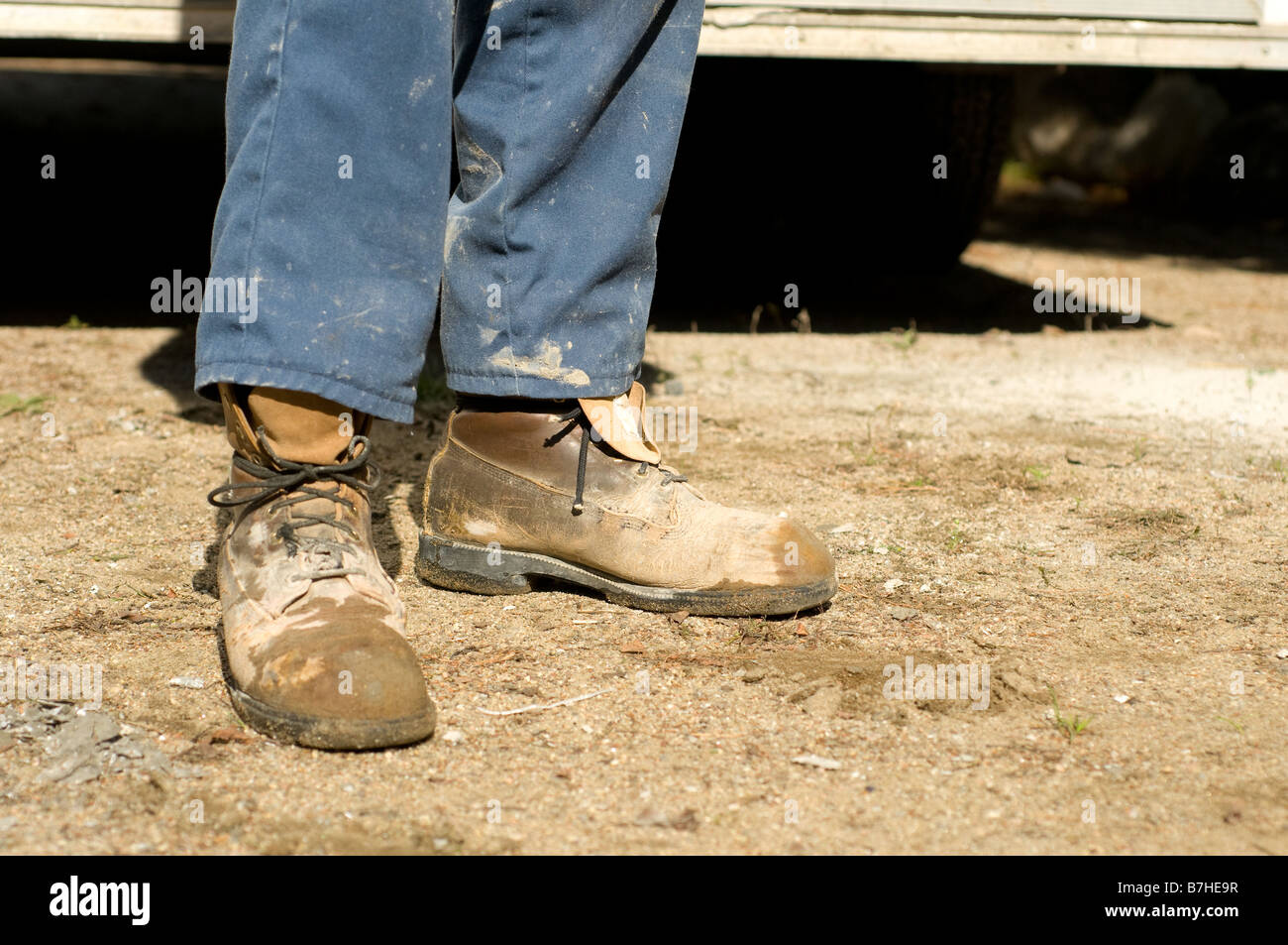 closeup of old and dirty cement worker boots Stock Photo