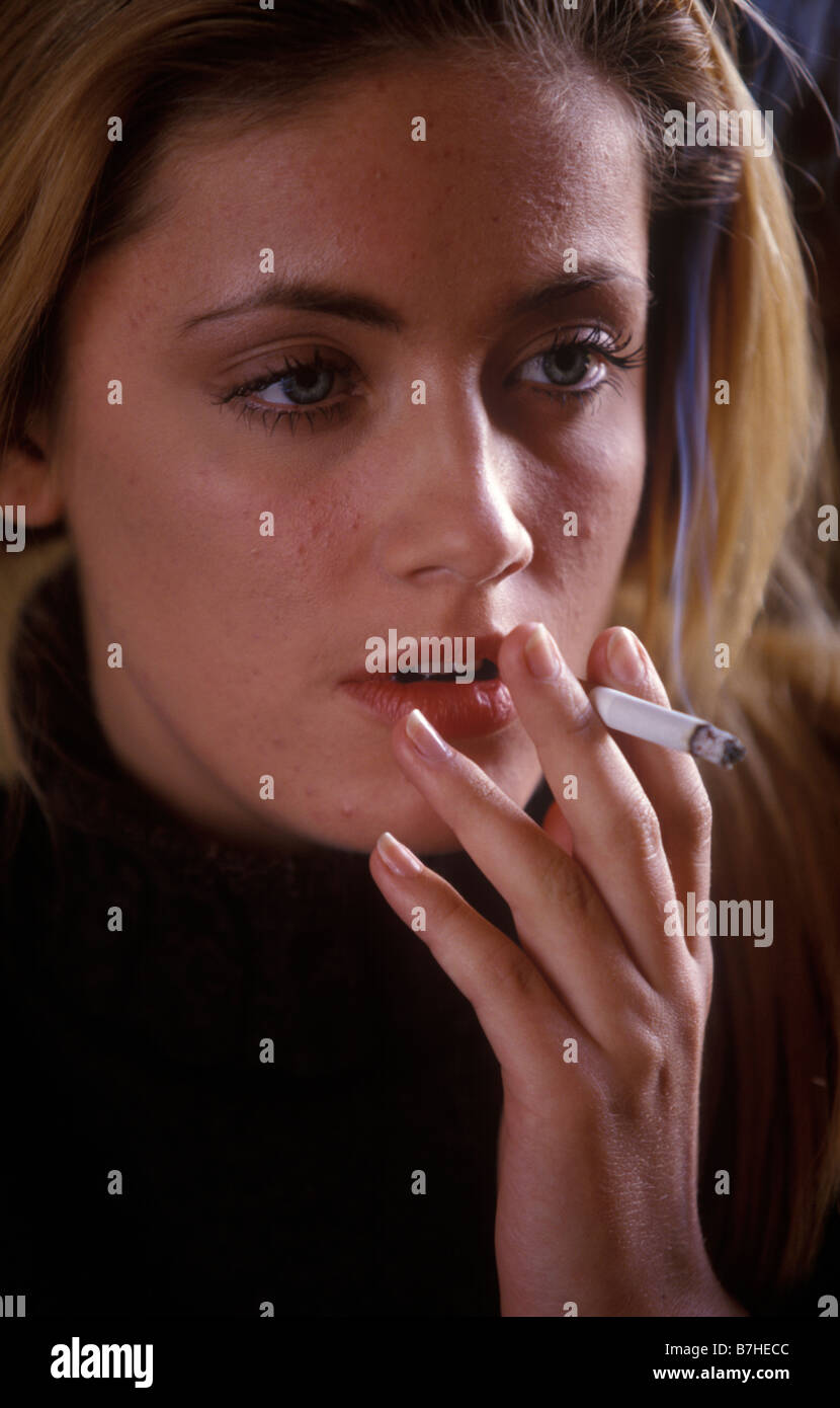 close up of a young woman smoking a cigarette Stock Photo