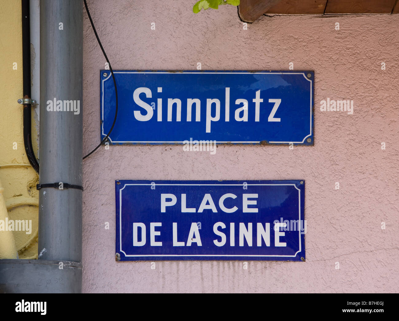 A lot of street signs in the languages german and french here the Place De La Sinne Stock Photo