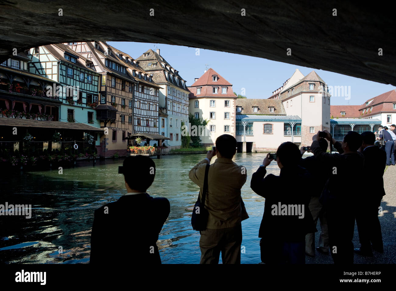 Asian tourists take a photograph of the half timbered houses at the Ill Stock Photo