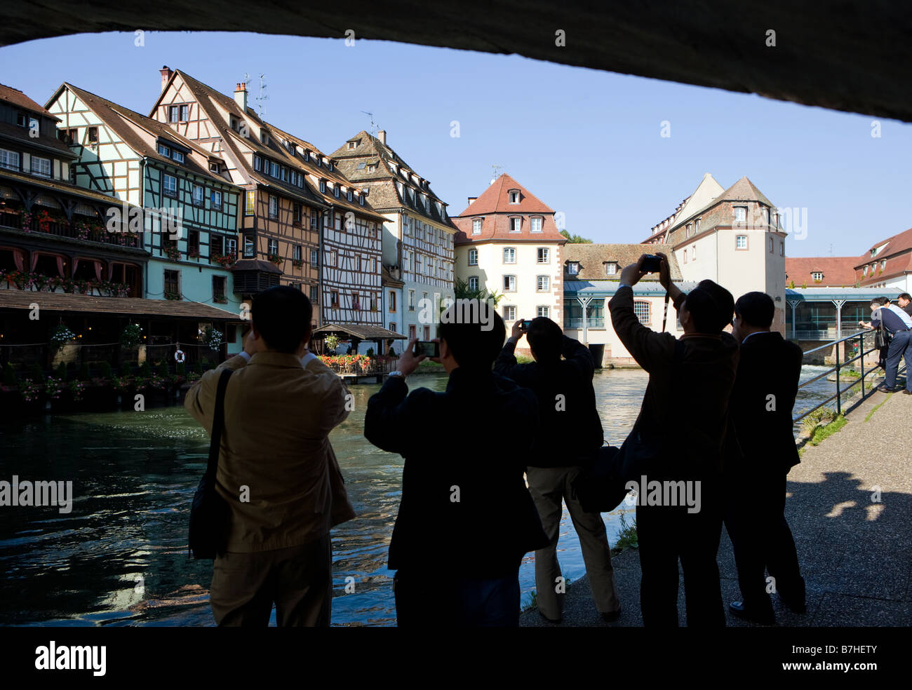 Asian tourists take a photograph of the half timbered houses at the Ill Stock Photo