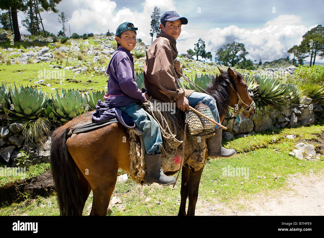 Two brothers mounted on a horse near San Nicolas Western Highlands Guatemala Stock Photo