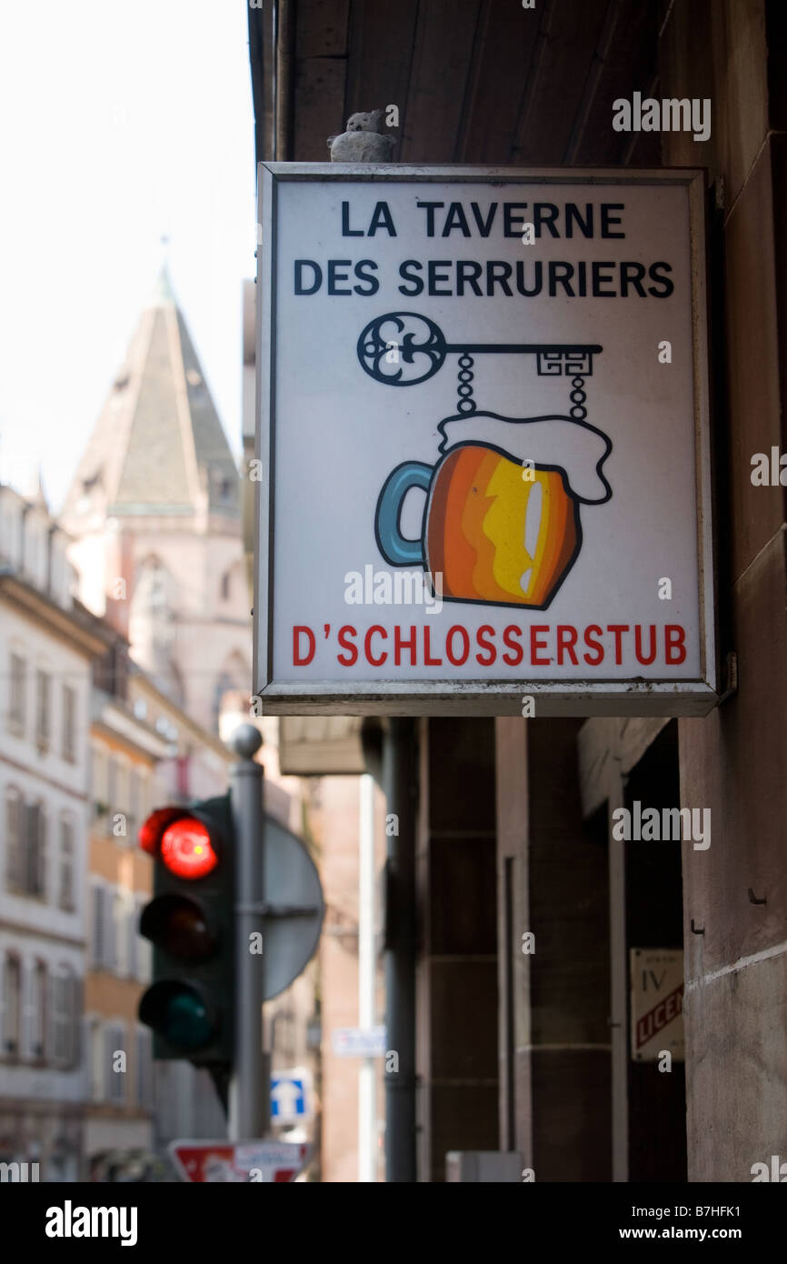 Sign of the tavern Schlosserstub In the background the church L Eglise St Thomas Stock Photo
