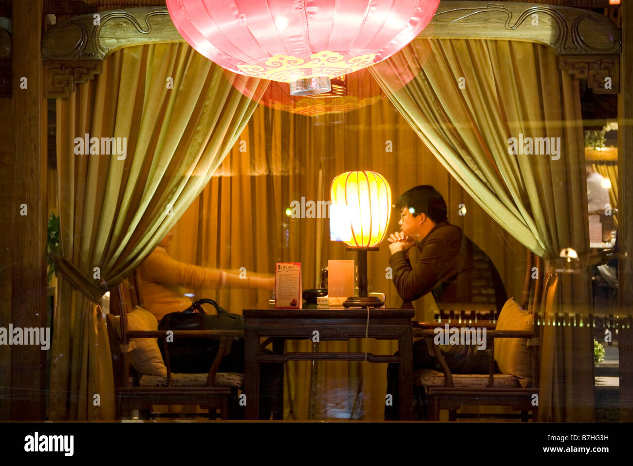 A couple in a private booth in a modern teahouse in China. Stock Photo