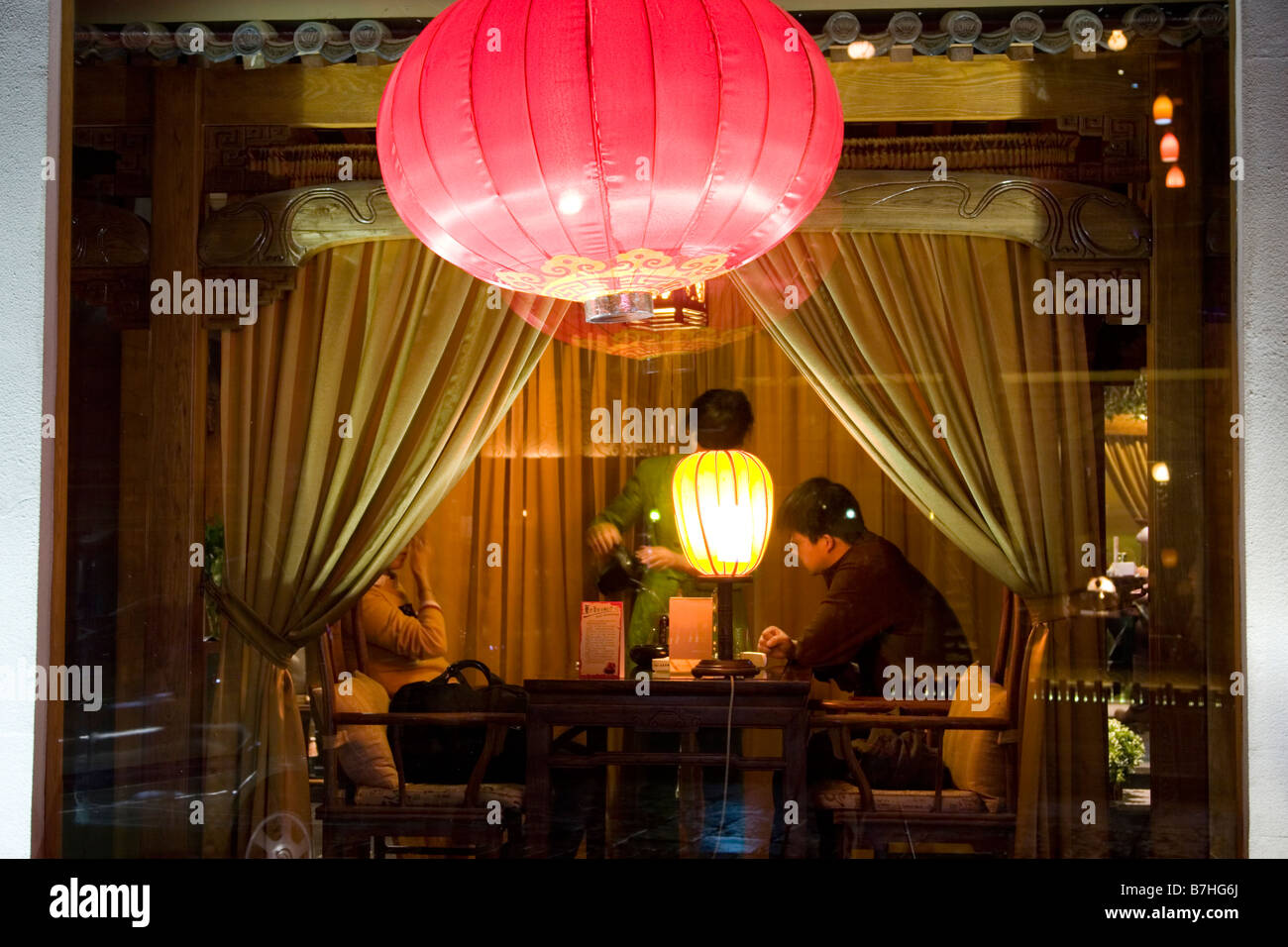 A couple in a private booth in a modern teahouse in China. Stock Photo
