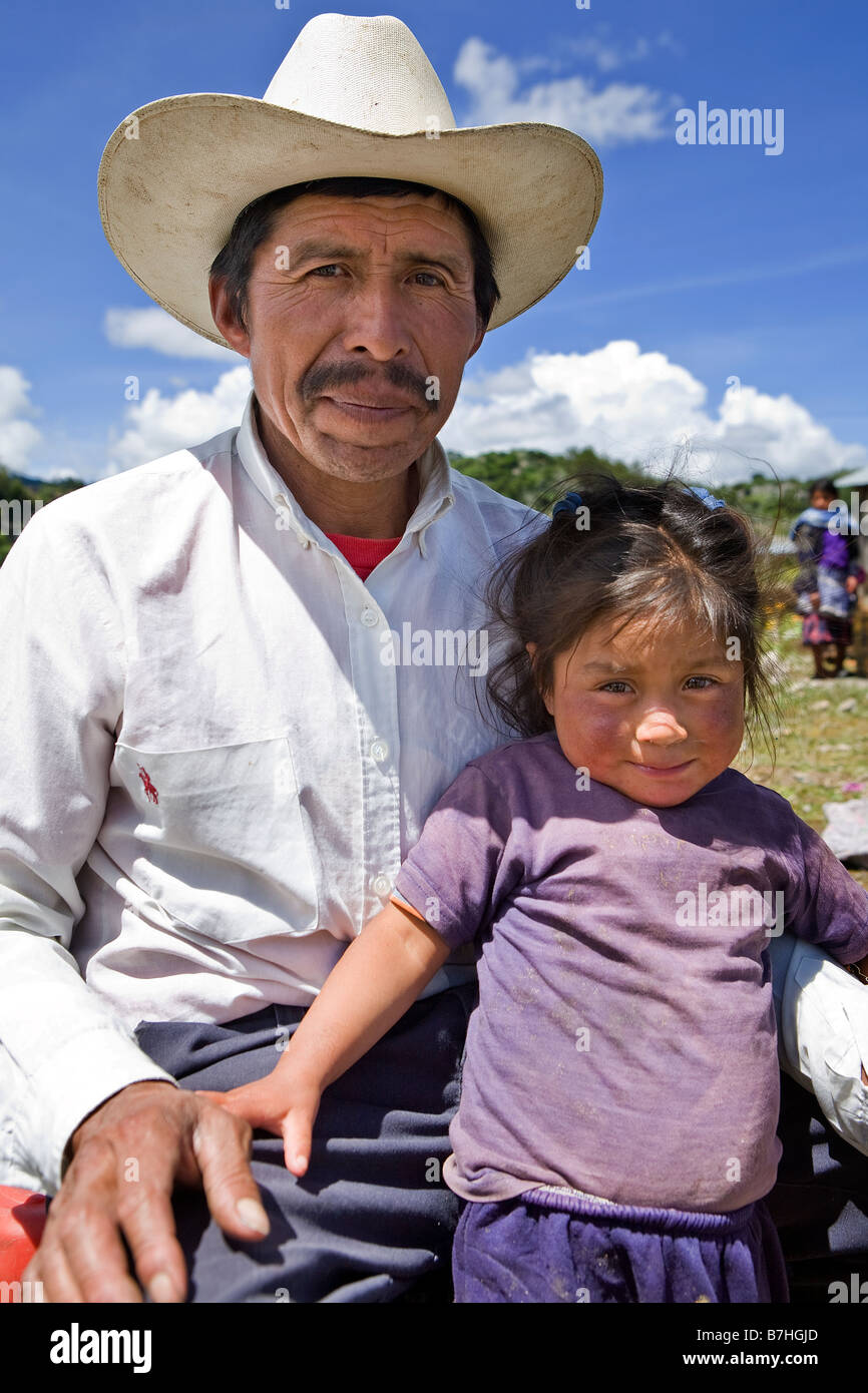 Guatemalan man poses with his daughter outside church San Nicolas Western Highlands Guatemala Stock Photo