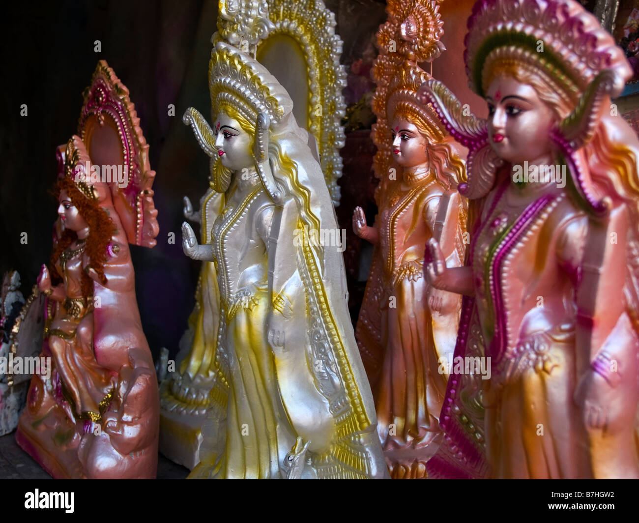mould-made plastic figures of the Hindu goddess Saraswati stand on a shelf in a workshop Stock Photo