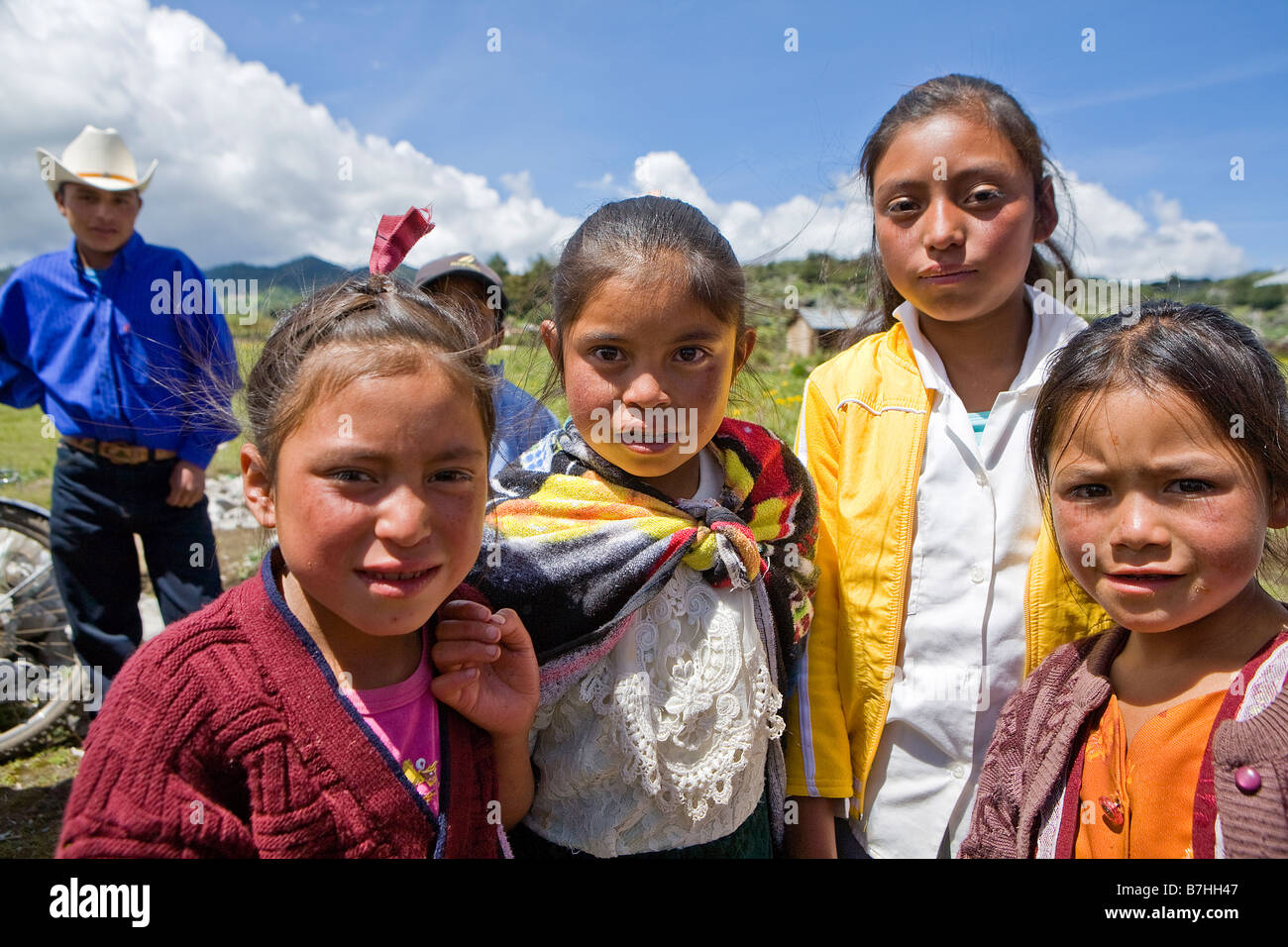 Four girls pose near a church in San Nicolas, Western Highlands, Guatemala Stock Photo