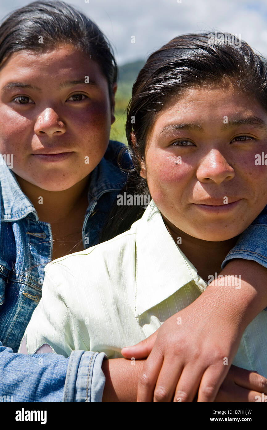 Two sisters pose together outside a church in San Nicolas, Western Highlands, Guatemala Stock Photo