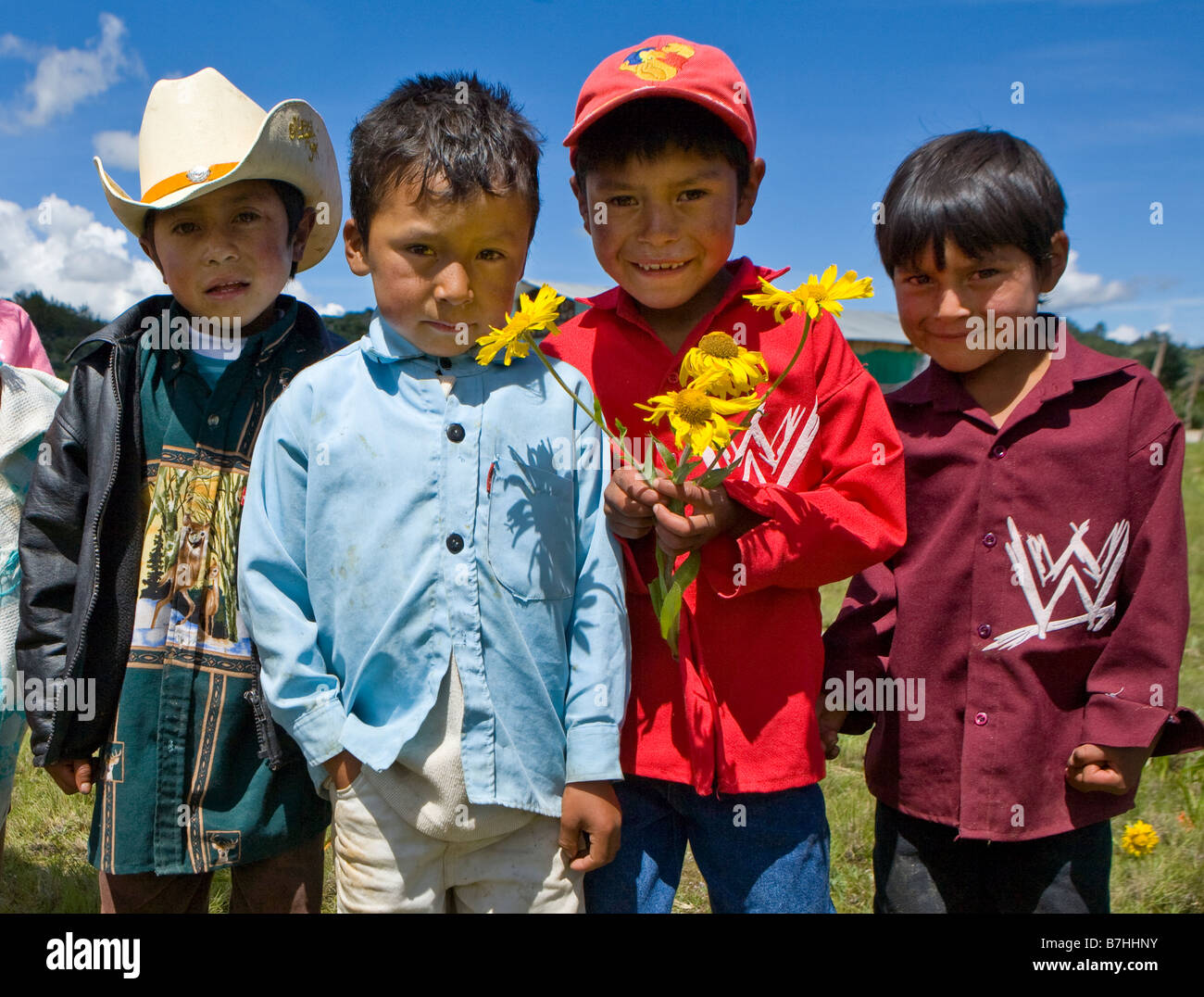 Four boys pose near a church in San Nicolas,  Western Highlands Guatemala Stock Photo