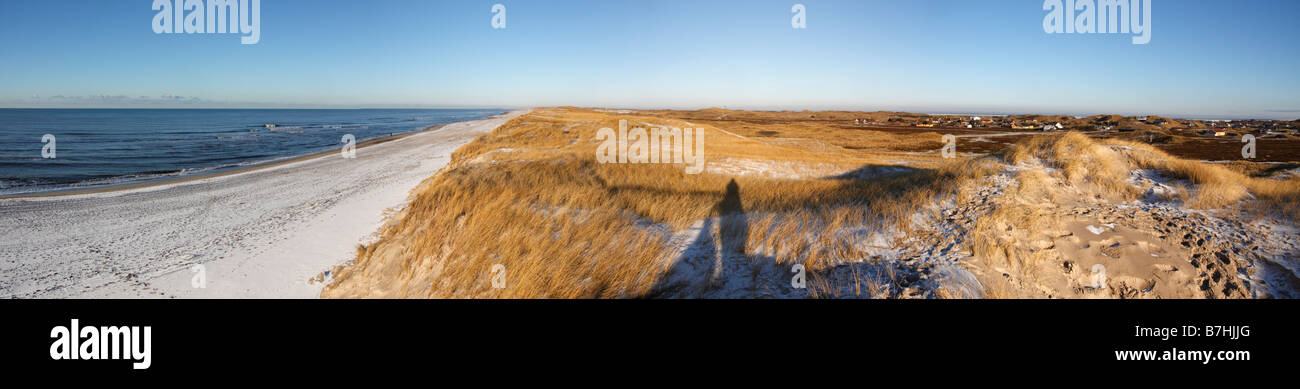 Wintery dunes and beach at Ringkobing, Hvide Sande, Denmark. The ground is covered with snow and frost. Stock Photo