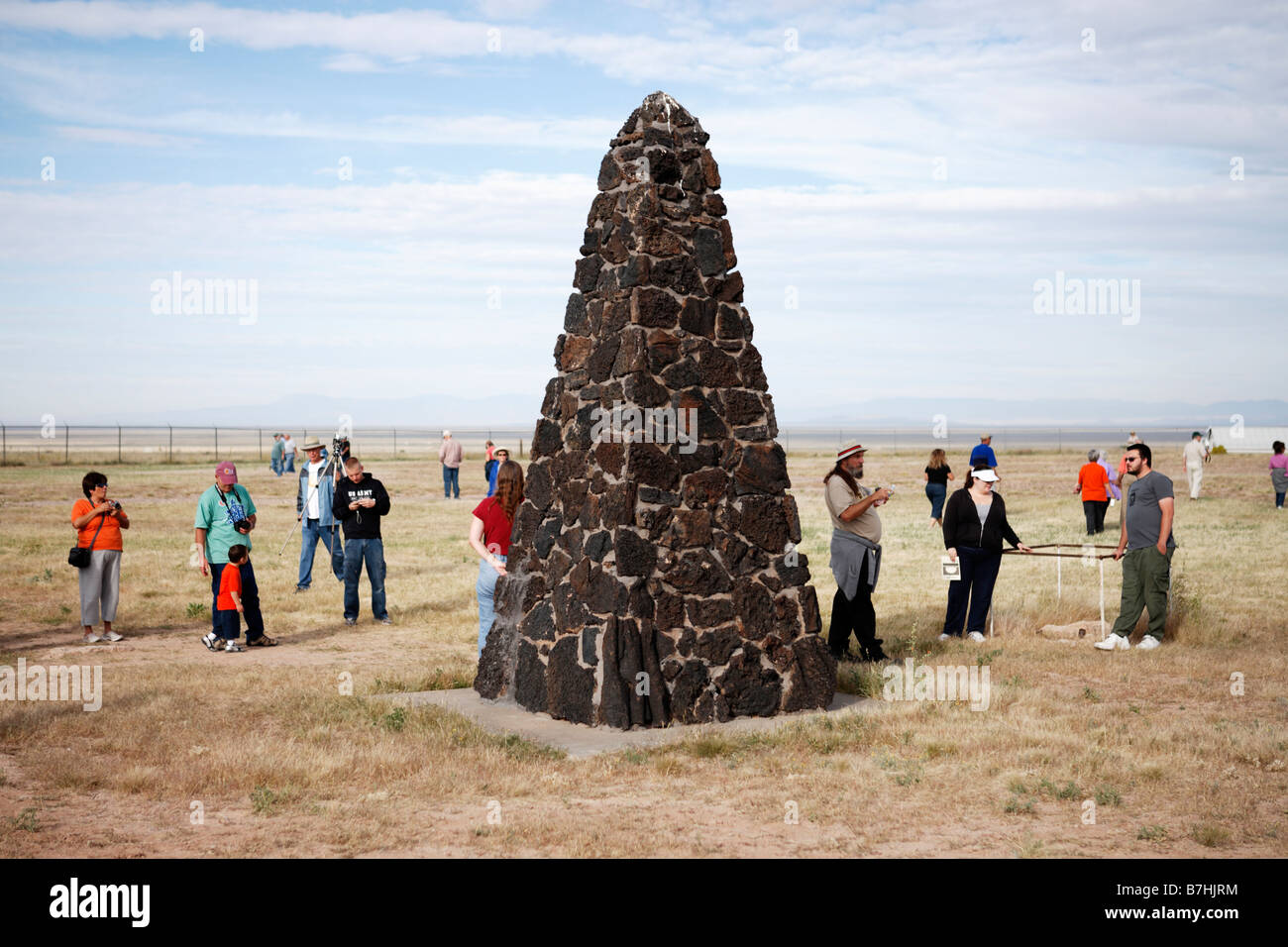 Sightseers gather around the obelisk marking the site of the world's first atomic explosion on July 16, 1945 at Trinity Site, NM Stock Photo