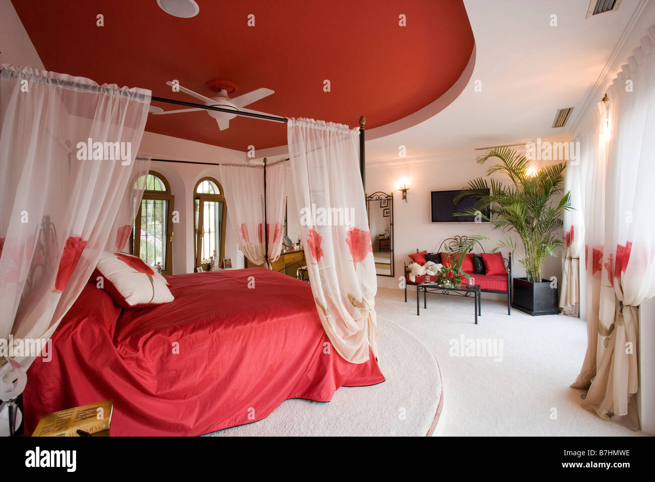 Red Ceiling Above Bed With White Voile Drapes And Red