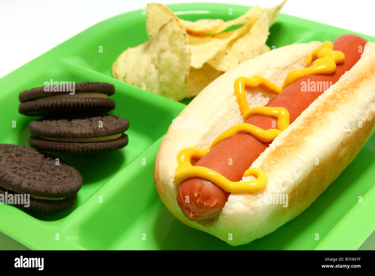 Hotdog chips cookies on childs tray Stock Photo