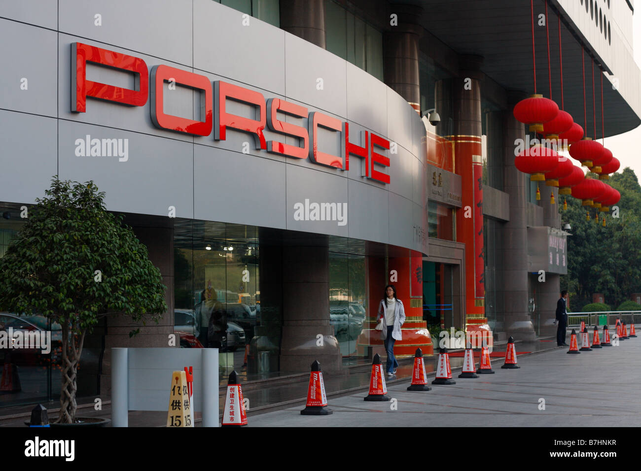 Porsche Dealership storefront with Chinese New Year Decorative Red Lanterns and Chinese Characters on sign Stock Photo