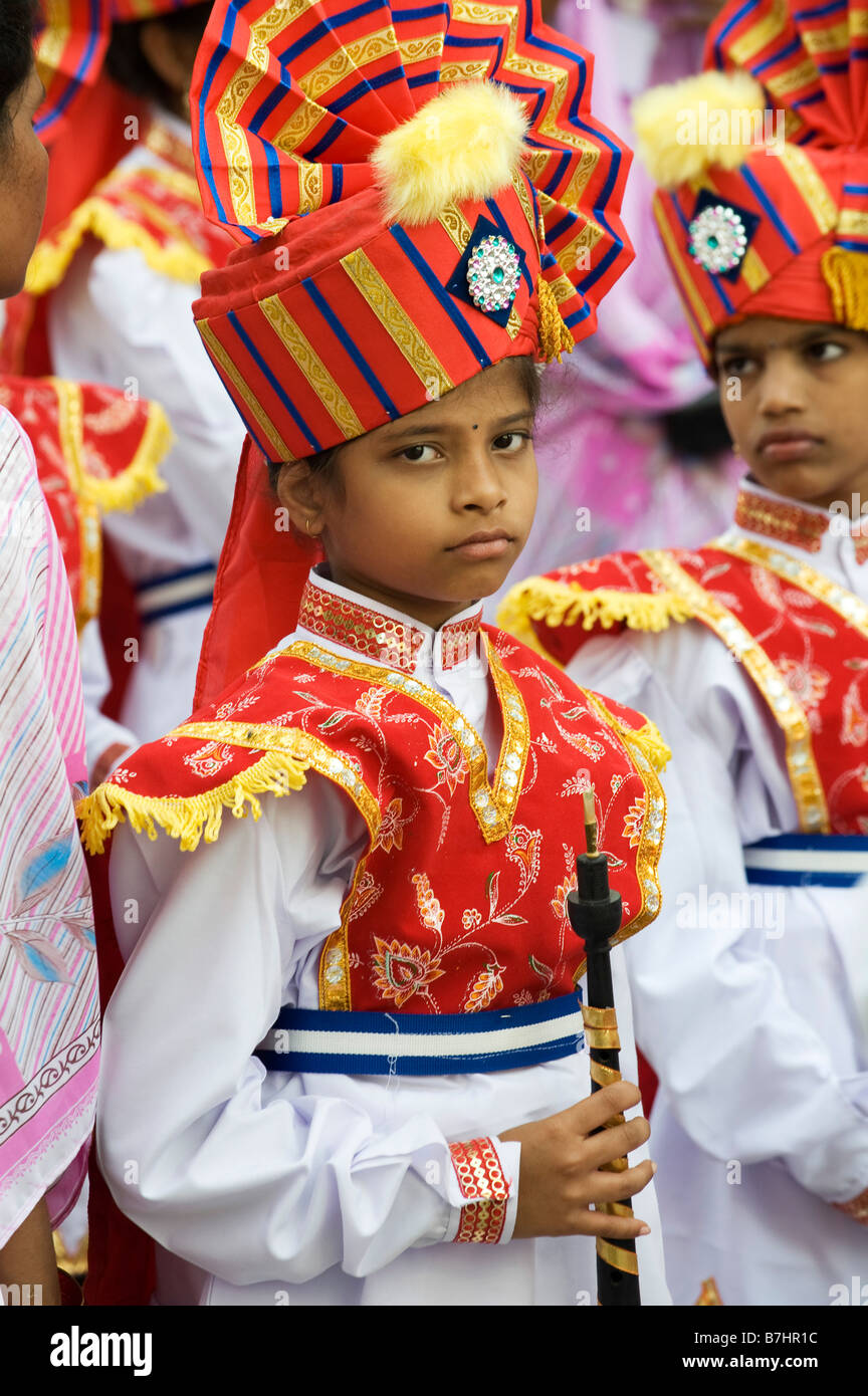 Colourful costumes of Indian Girls in a marching band in a street pageant in the town of Puttaparthi, Andhra Pradesh, India Stock Photo