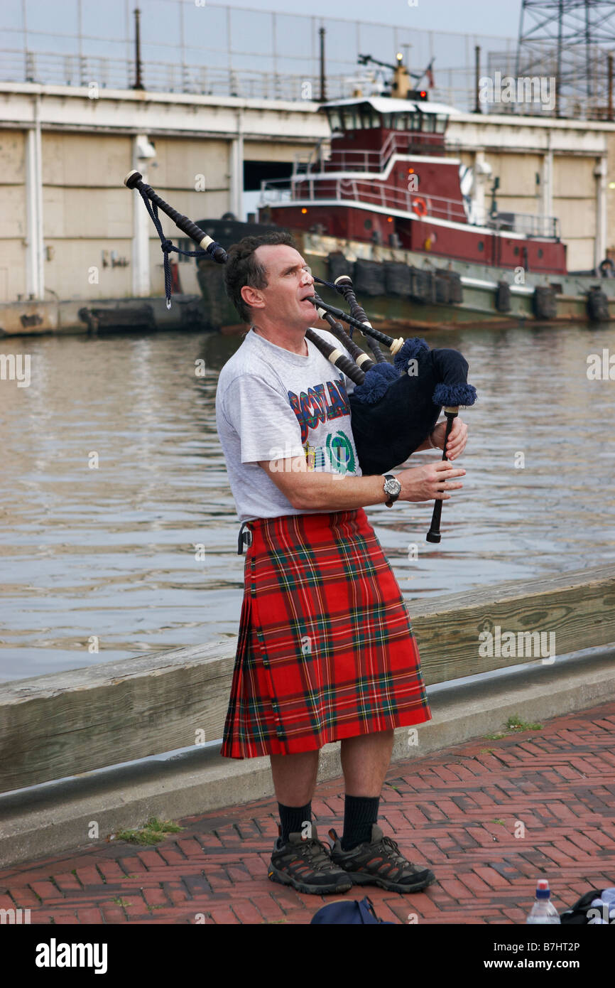 A bagpiper on a dock at Fell s Point Baltimore Maryland Stock Photo