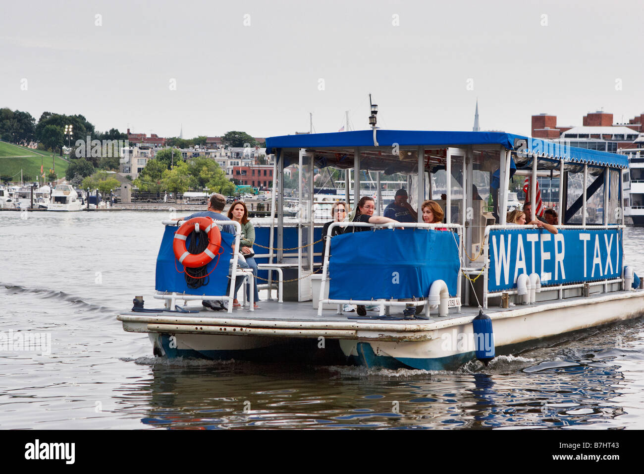 A water taxi approaches its pier on the Inner Harbor Baltimore Maryland Stock Photo