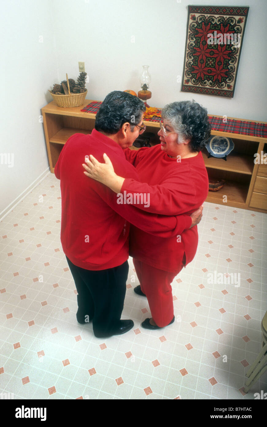 Senior Hispanic couple dance in home Stock Photo - Alamy