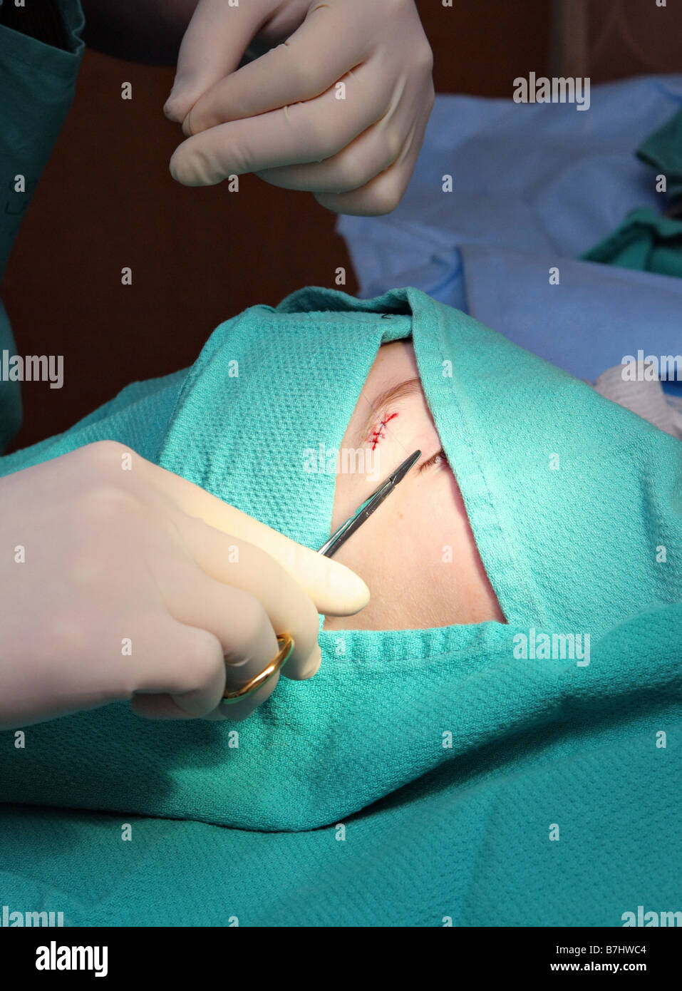 little boy in emergency room having cut stitched up by doctor Stock Photo