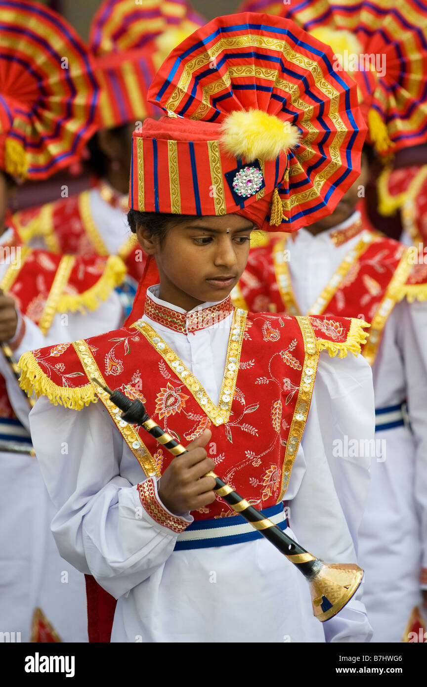 Colourful costumes of Indian Girls in a marching band in a street pageant in the town of Puttaparthi, Andhra Pradesh, India Stock Photo